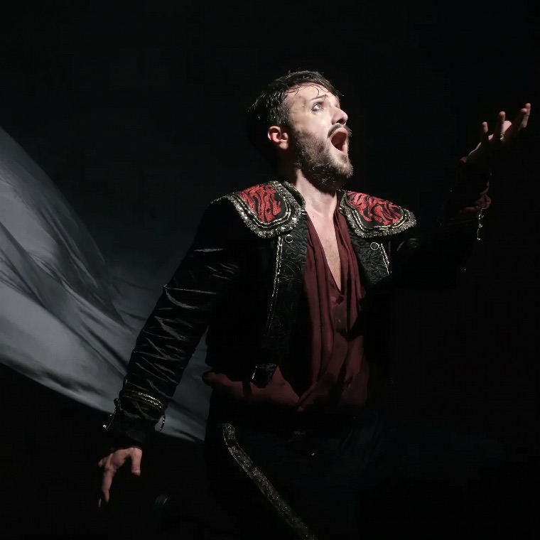 Luka Jozic singing in a dramatic black and crimson costume